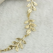 Hårbånd med guld grene og blade